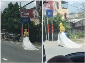 Xôn xao hình ảnh 'cô gái' diện váy cưới 'phối' áo chống nắng đi lang thang trên đường: 'Từng chịu cú sốc lớn' hay 'ở rảnh câu view'?